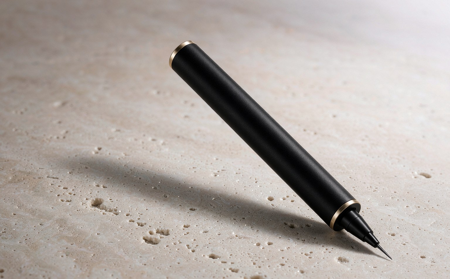 Slim automatic eyeliner pen in matte black with champagne gold collar