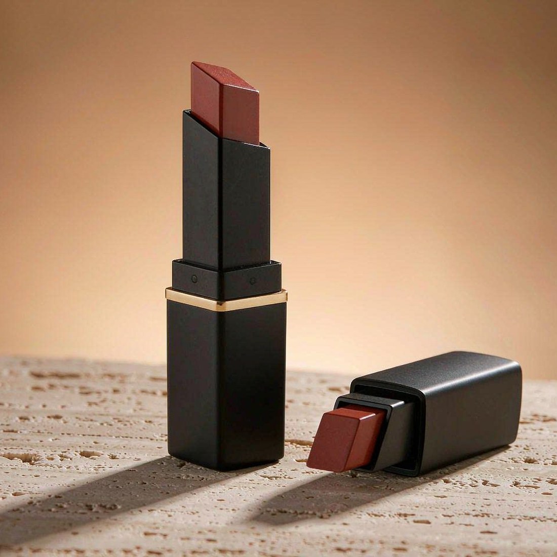 Luxury lipstick case in matte black with champagne gold waist ring